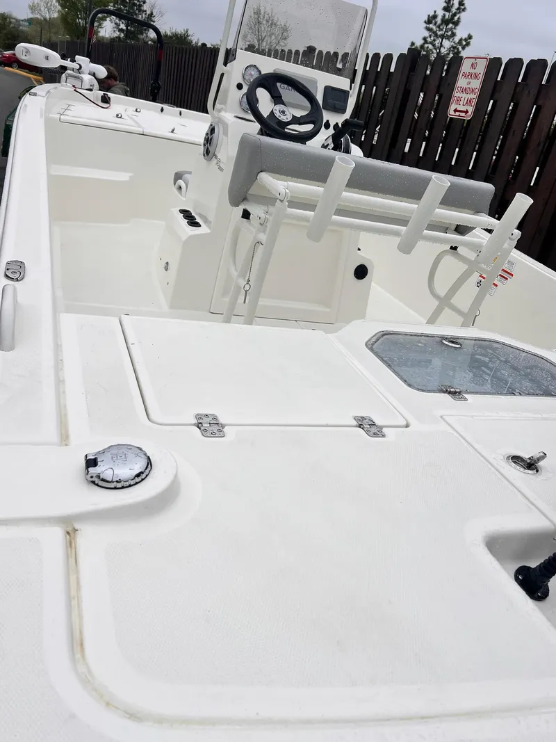 Slide: The Image of 2025 Mako Pro Skiff 19 CC boat interior with steering console and seating. - 2