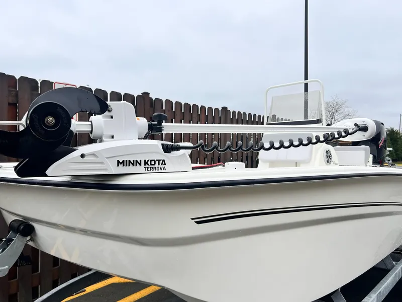 Slide: The Image of 2025 Mako Pro Skiff 19 CC with Minn Kota Terrova trolling motor, parked outdoors. - 3