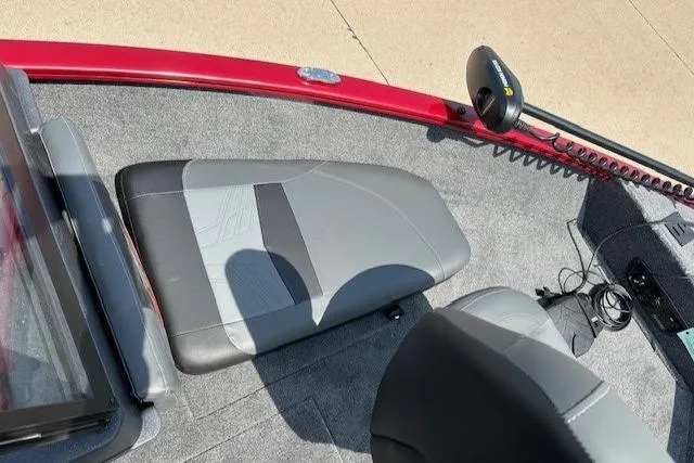 Slide: The Image of 2025 Tracker Pro Guide V-175 Combo boat interior with gray seating and red trim. - 4