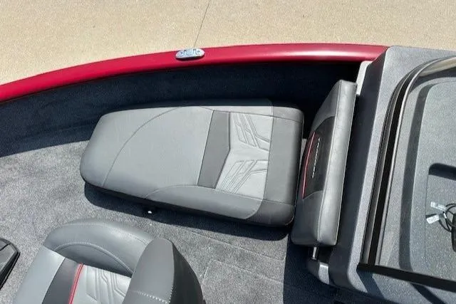 Slide: The Image of 2025 Tracker Pro Guide V-175 Combo boat interior with gray seating and red accents. - 5