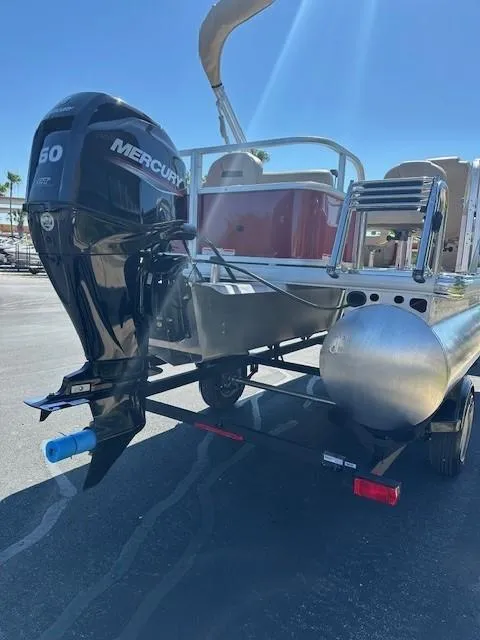Slide: The Image of 2025 Sun Tracker Bass Buggy 18 DLX pontoon boat with Mercury 60 HP engine on trailer. - 5