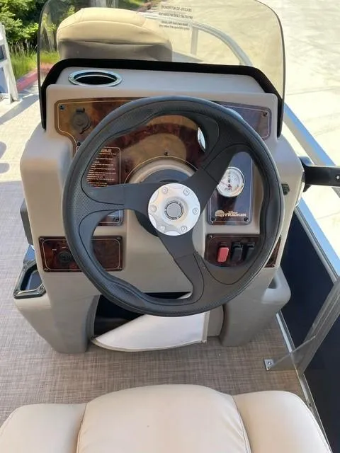 Slide: The Image of 2025 Sun Tracker Bass Buggy 18 DLX steering console with modern controls and comfortable seating. - 4