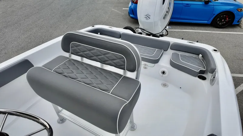 Slide: The Image of 2025 ALK2 Powerboats 22CRX interior with gray seating and Suzuki outboard motor. - 10
