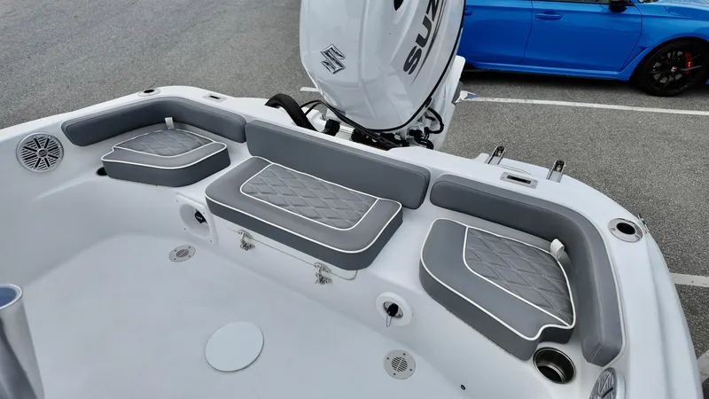 Slide: The Image of 2025 ALK2 Powerboats 22CRX interior with gray seating and Suzuki outboard motor. - 11