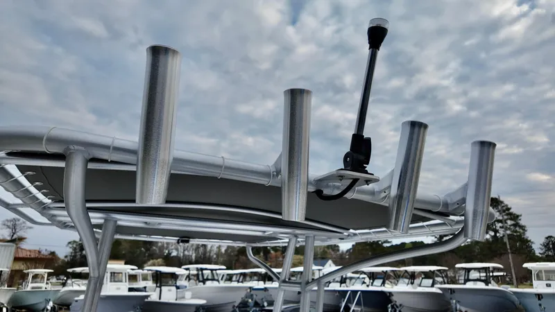 Slide: The Image of 2025 ALK2 Powerboats 22CRX with rod holders and antenna under a cloudy sky. - 14