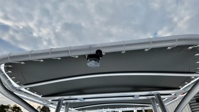 Slide: The Image of 2025 ALK2 Powerboats 22CRX canopy with sleek design under cloudy sky. - 15