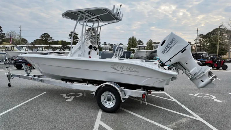 Slide: The Image of 2025 ALK2 Powerboats 22CRX on trailer with Suzuki outboard motor in parking lot. - 2
