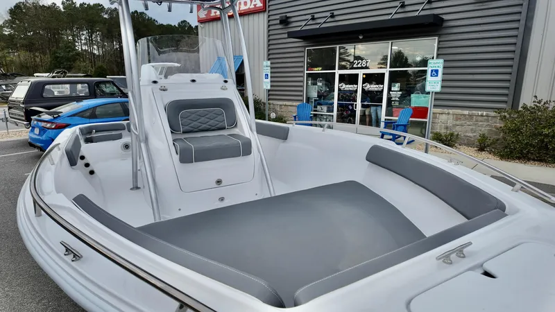 Slide: The Image of 2025 ALK2 Powerboats 22CRX, sleek design, parked outside dealership. - 6