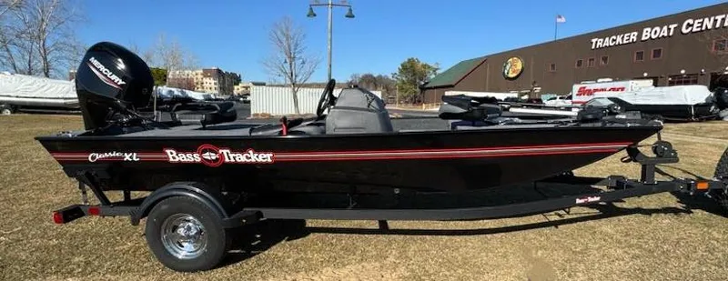 Slide: The Image of 2025 Tracker Bass Tracker Classic XL boat on trailer, parked outdoors near Tracker Boat Center. - 5