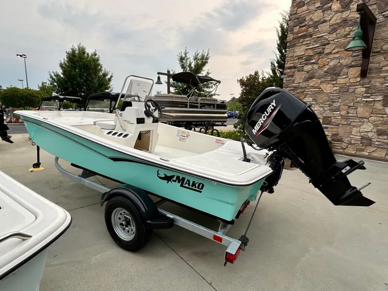 Slide: The Image of 2025 Mako Pro Skiff 15 CC boat with Mercury engine on trailer. - 3