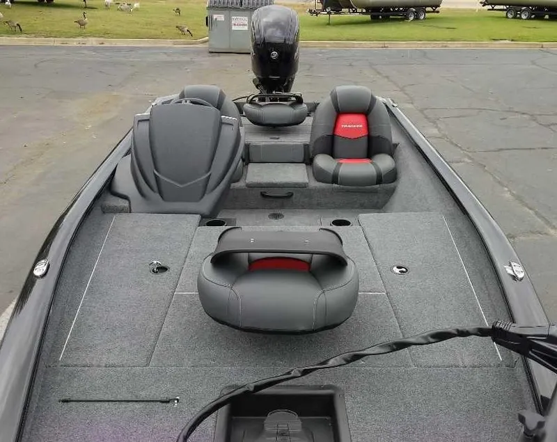 Slide: The Image of 2025 Tracker Pro Team 175 Crappie Edition boat interior with seating and motor. - 7