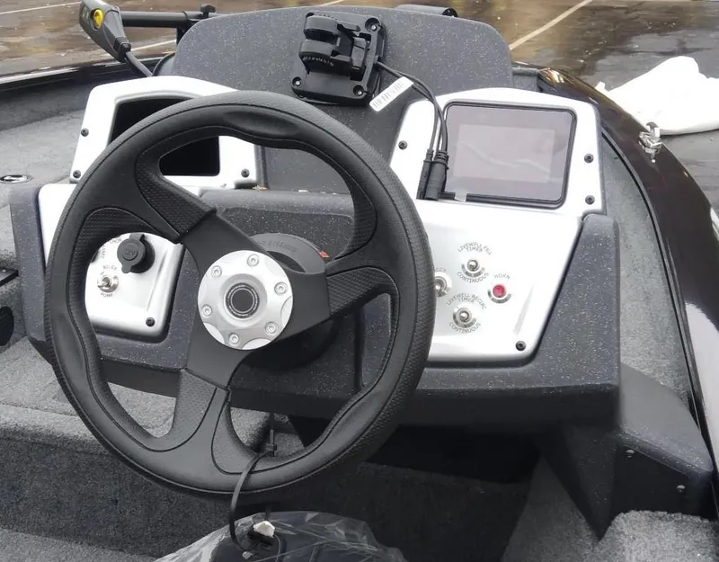Slide: The Image of 2025 Tracker Pro Team 175 Crappie Edition boat dashboard with steering wheel and controls. - 8