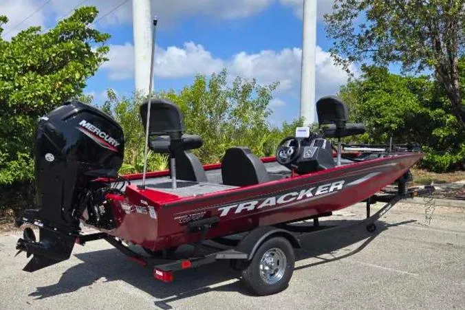 Slide: The Image of 2025 Tracker Pro Team 175 boat with Mercury engine, parked outdoors. - 10