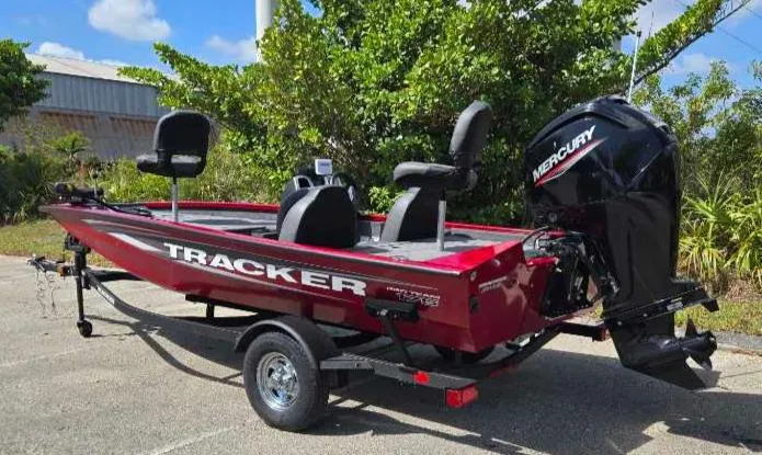 Slide: The Image of 2025 Tracker Pro Team 175 boat with Mercury engine, parked outdoors. - 11