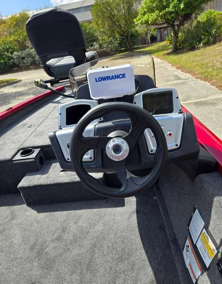 Slide: The Image of 2025 Tracker Pro Team 175 boat dashboard with Lowrance electronics, steering wheel, and seating. - 6