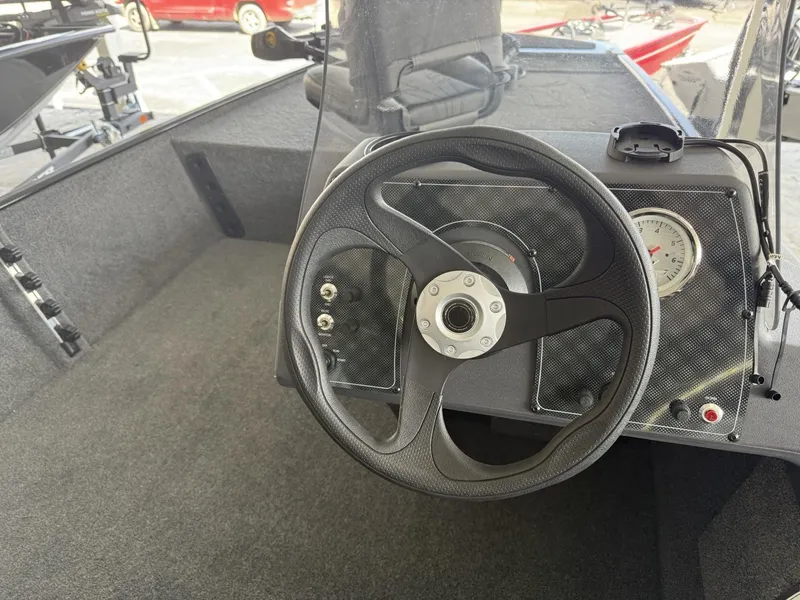 Slide: The Image of Steering wheel of 2025 Tracker Bass Tracker Classic XL boat interior. - 13