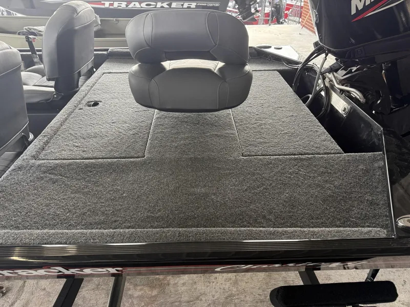 Slide: The Image of 2025 Tracker Bass Tracker Classic XL boat with cushioned seating and carpeted deck. - 4