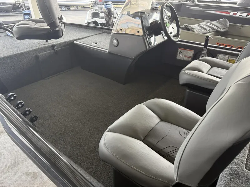 Slide: The Image of 2025 Tracker Bass Tracker Classic XL boat interior with seating and steering console. - 5