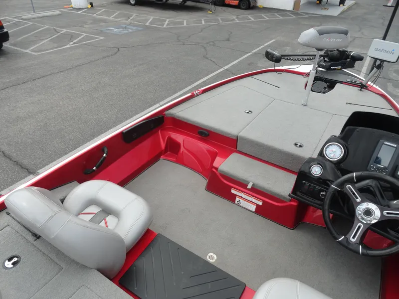 Slide: The Image of 2018 Nitro Z17 boat interior with steering wheel and seating, parked in a lot. - 14