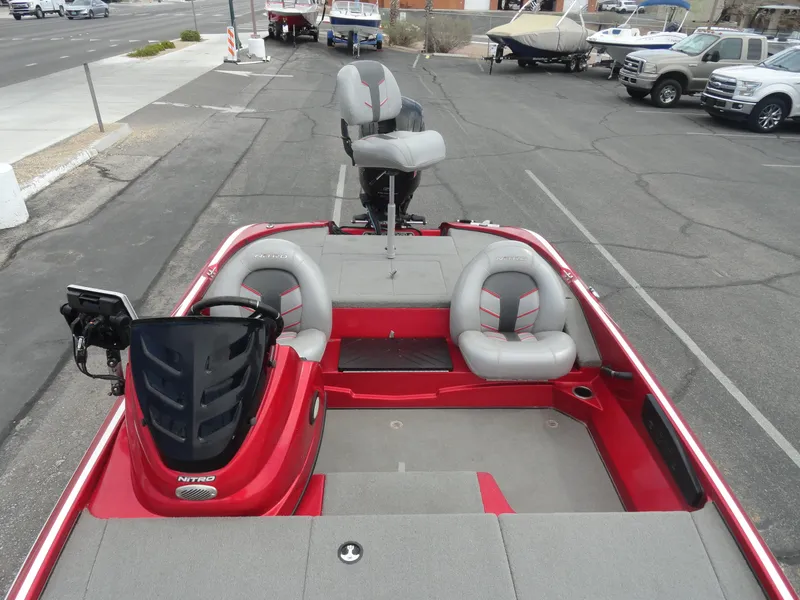 Slide: The Image of 2018 Nitro Z17 boat with red and gray seating, parked in a lot. - 20