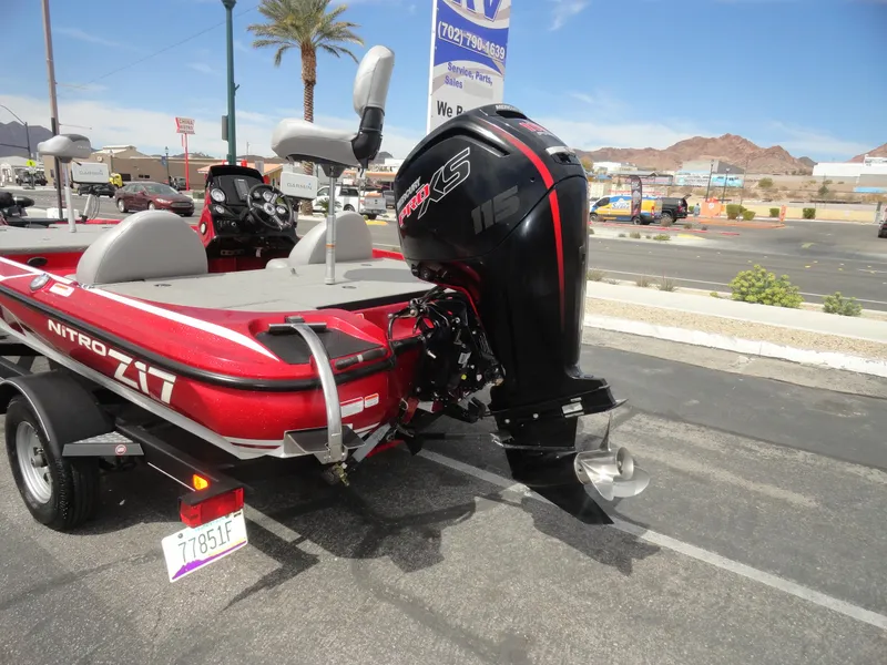Slide: The Image of Red 2018 Nitro Z17 boat with powerful outboard motor, parked on a trailer in a sunny lot. - 24
