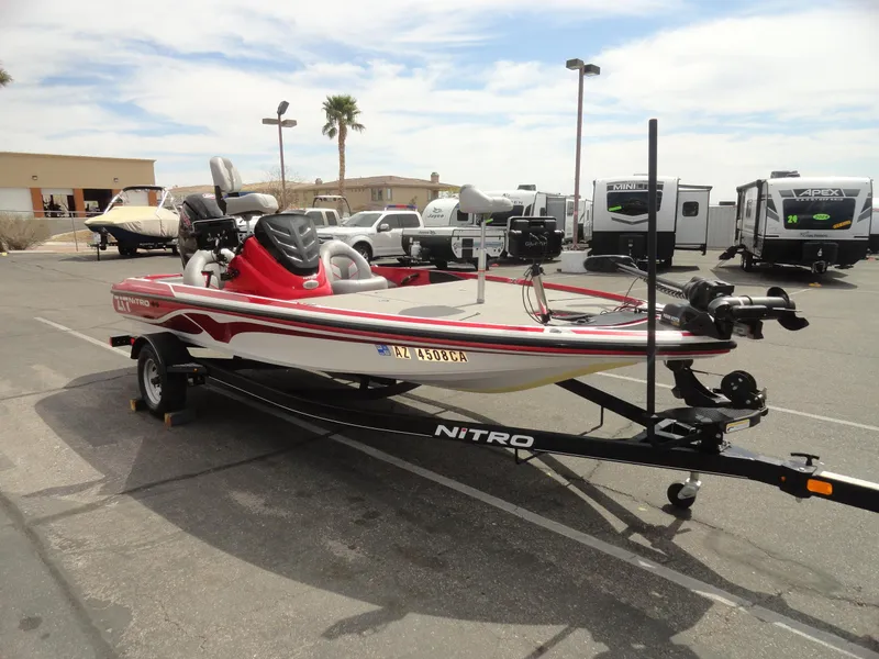 Slide: The Image of 2018 Nitro Z17 boat on trailer in parking lot, surrounded by RVs and palm trees. - 4