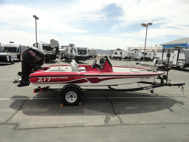 Slide: The Image of 2018 Nitro Z17 boat with trailer in a parking lot, surrounded by RVs. - 5