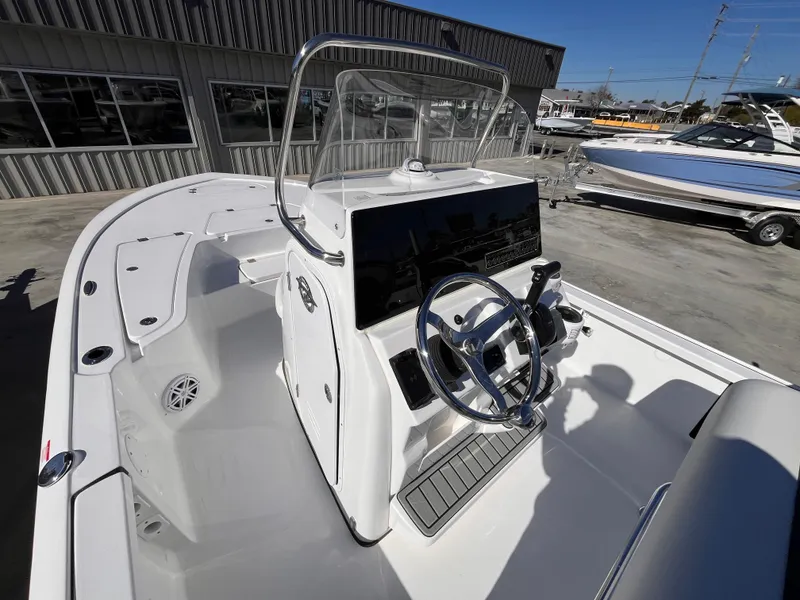 Slide: The Image of 2025 Tidewater 2110 Bay Max boat interior with steering console and seating. - 10