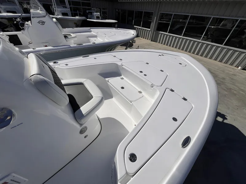 Slide: The Image of 2025 Tidewater 2110 Bay Max boat deck with seating and storage compartments. - 8