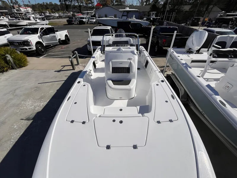 Slide: The Image of 2025 Tidewater 2110 Bay Max boat in a marina, surrounded by vehicles and other boats. - 9