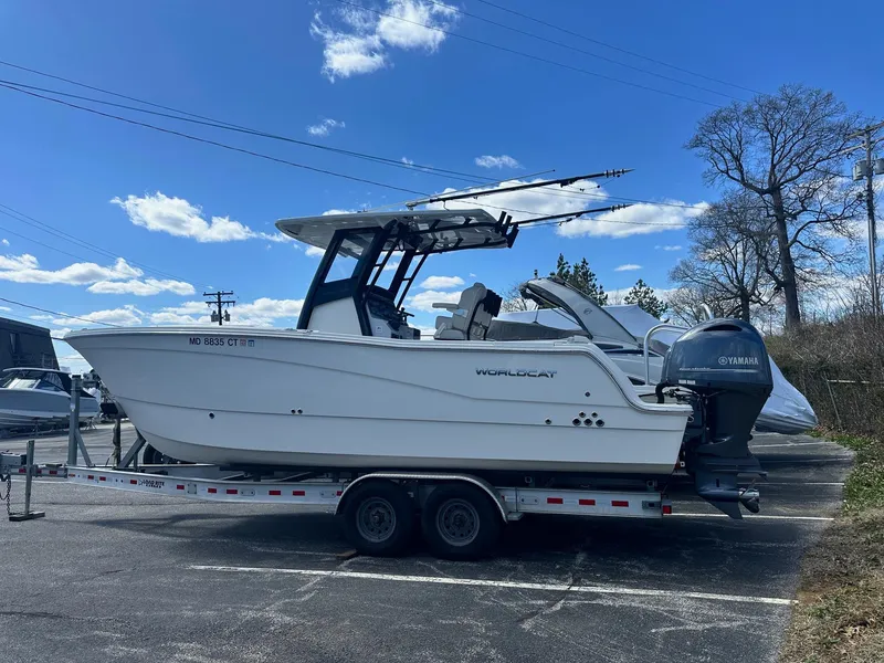Slide: The Image of 2023 World Cat 260 CC-X boat on trailer under blue sky. - 0