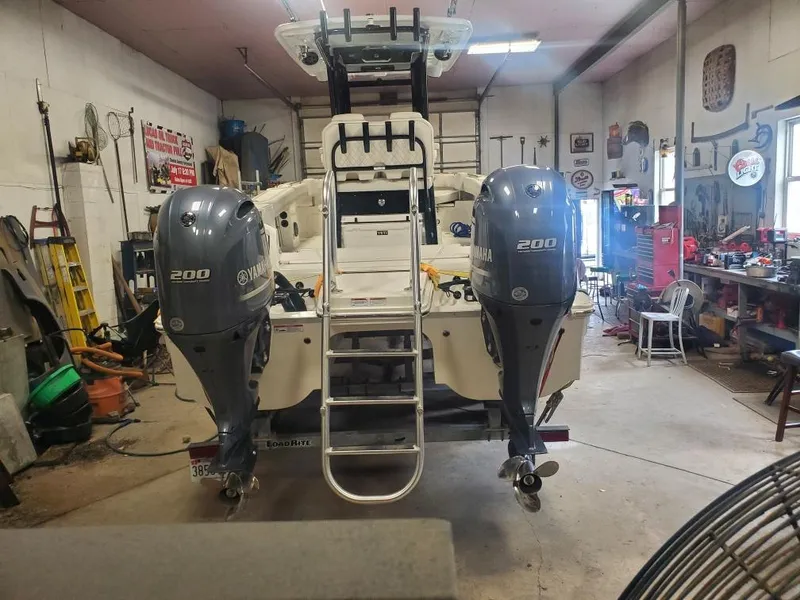 Slide: The Image of 2023 World Cat 260 CC-X boat with dual Yamaha 200 engines in a garage. - 12