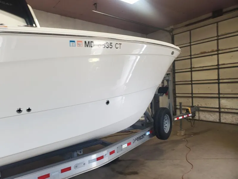 Slide: The Image of 2023 World Cat 260 CC-X boat on trailer in garage setting. - 14