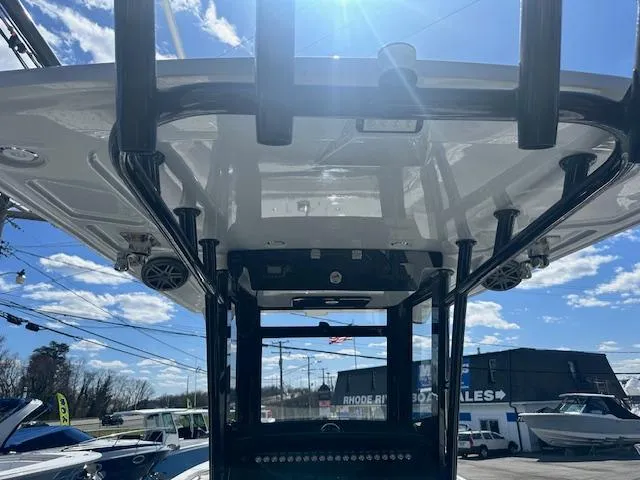 Slide: The Image of 2023 World Cat 260 CC-X boat with T-top, viewed from below, against a clear blue sky. - 17