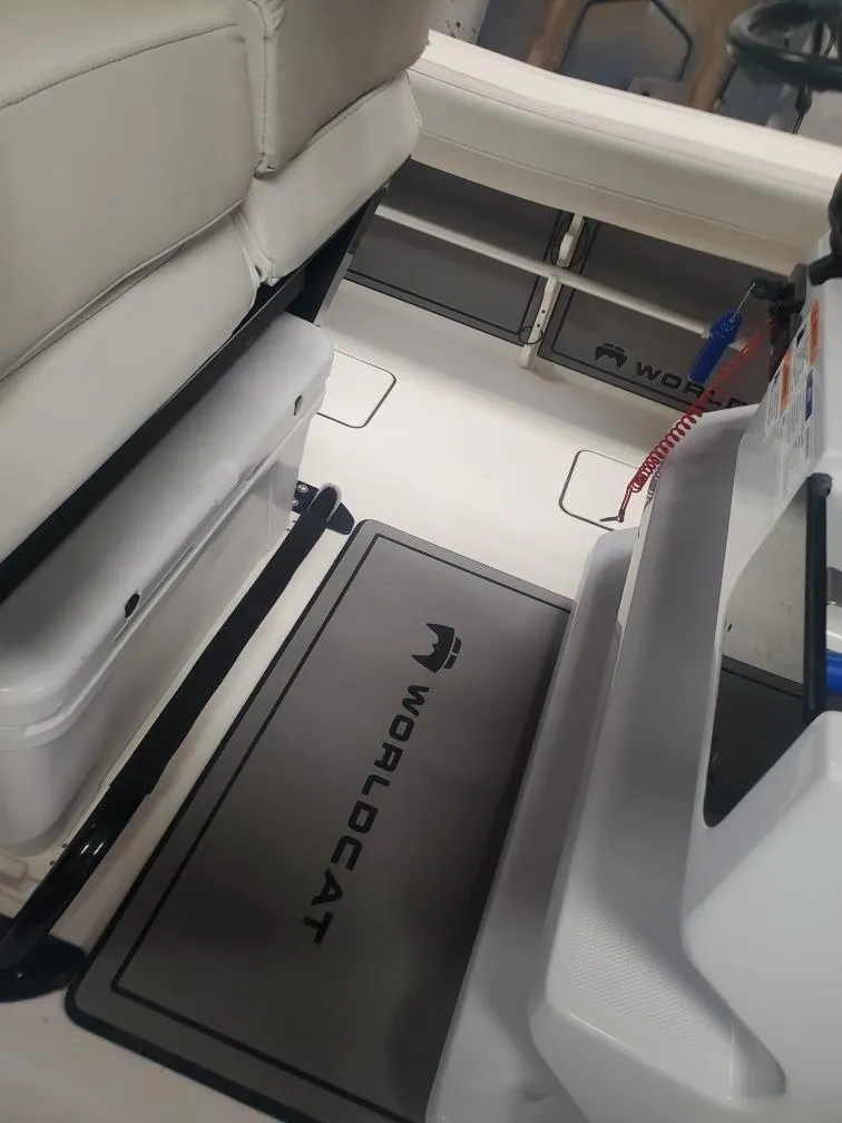 Slide: The Image of 2023 World Cat 260 CC-X boat interior with branded flooring and seating. - 23