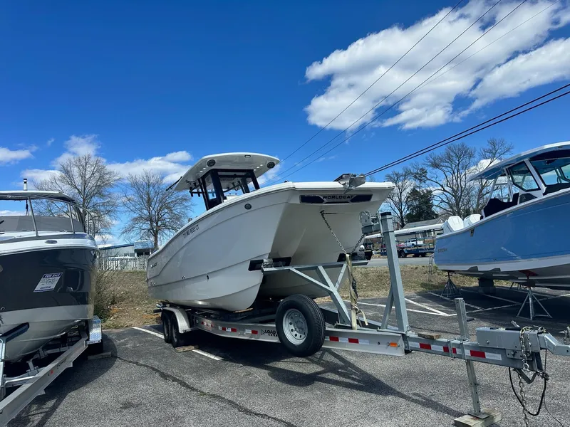 Slide: The Image of 2023 World Cat 260 CC-X boat on trailer under blue sky. - 3
