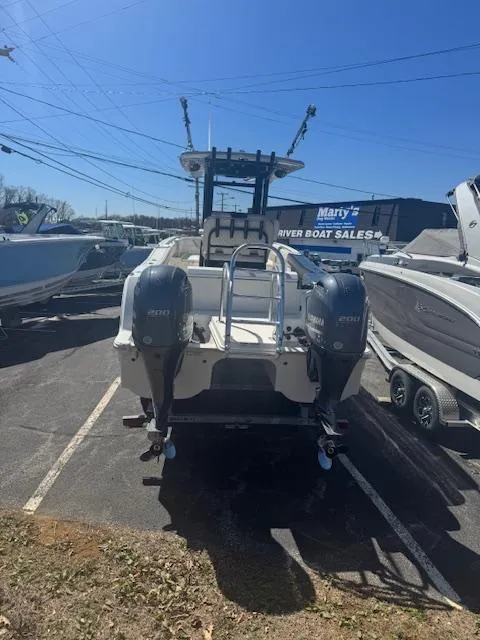 Slide: The Image of 2023 World Cat 260 CC-X boat at dealership, rear view with twin engines. - 5