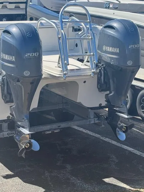 Slide: The Image of 2023 World Cat 260 CC-X with dual Yamaha 200 outboard engines, parked on a trailer. - 7