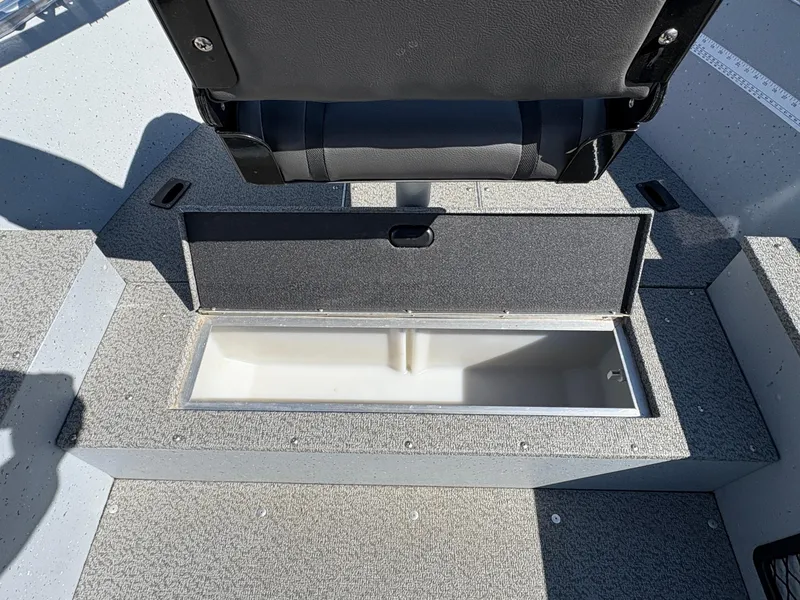 Slide: The Image of 2021 Lund 1600 Fury Tiller boat with open storage compartment under seat. - 14