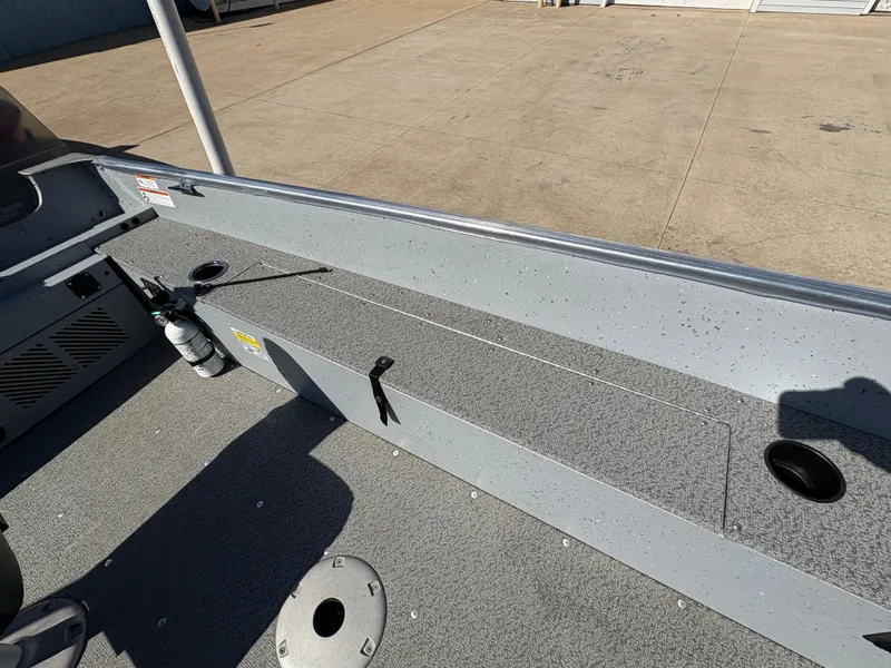 Slide: The Image of 2021 Lund 1600 Fury Tiller boat interior with storage compartments and fishing rod holders. - 18