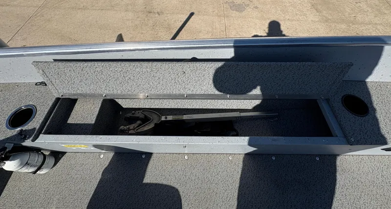 Slide: The Image of 2021 Lund 1600 Fury Tiller boat storage compartment with open lid, showing interior space. - 19