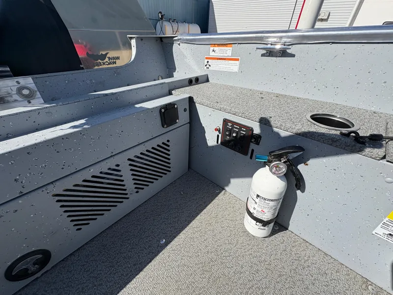 Slide: The Image of 2021 Lund 1600 Fury Tiller boat interior with fire extinguisher and control panel. - 20