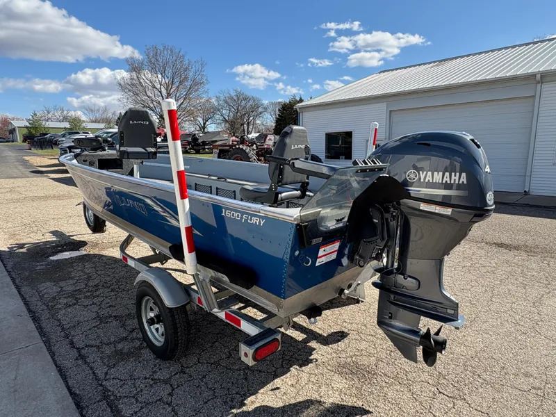 Slide: The Image of 2021 Lund 1600 Fury Tiller boat with Yamaha outboard motor on a trailer. - 3