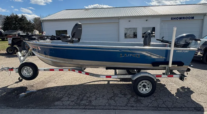 Slide: The Image of 2021 Lund 1600 Fury Tiller boat on trailer outside showroom. - 4