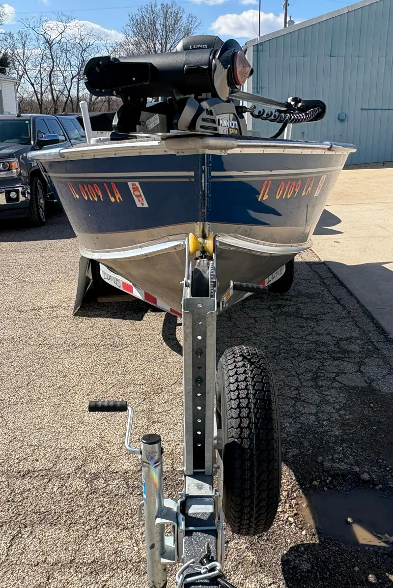 Slide: The Image of 2021 Lund 1600 Fury Tiller boat on trailer, parked outdoors. - 6