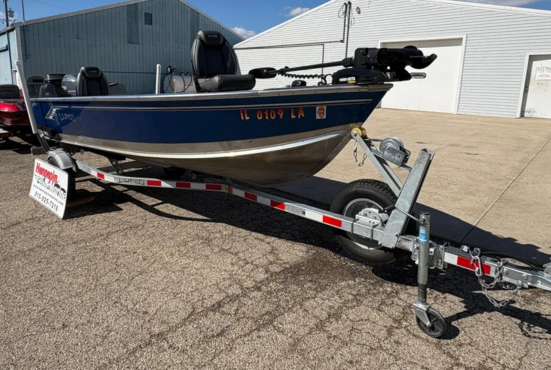 Slide: The Image of 2021 Lund 1600 Fury Tiller boat on trailer, parked outdoors. - 7