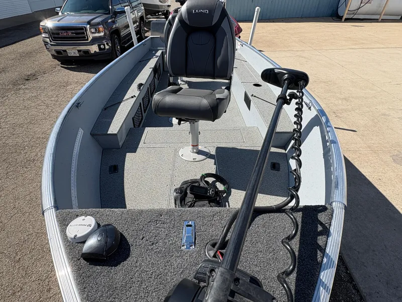 Slide: The Image of 2021 Lund 1600 Fury Tiller boat with seating and steering, parked outdoors. - 8