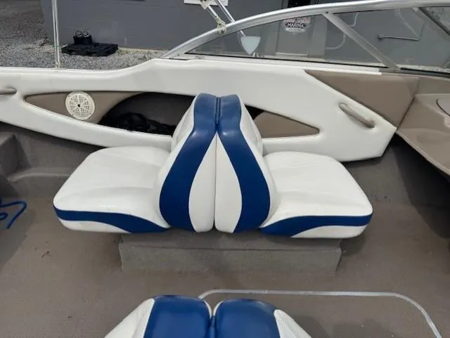 Slide: The Image of 2005 Bayliner 195 Bowrider interior with blue and white seating. - 6