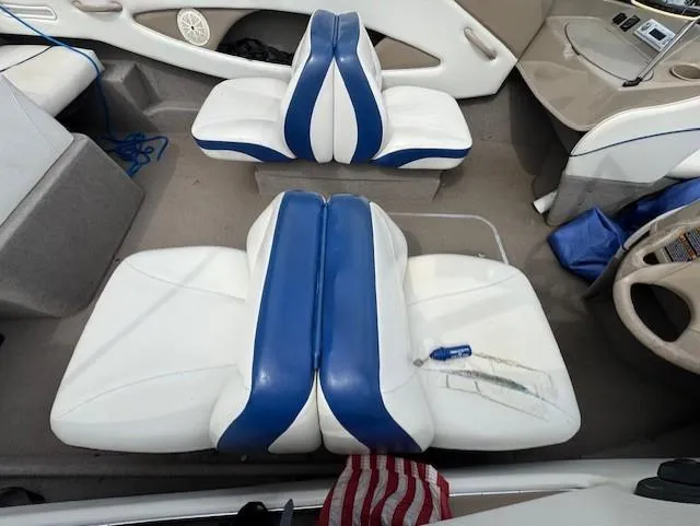 Slide: The Image of 2005 Bayliner 195 Bowrider interior with blue and white seating arrangement. - 7