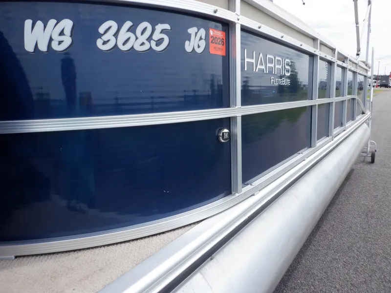 Slide: The Image of 2013 Harris FloteBote Cruiser 240 pontoon boat with registration details on the side. - 10